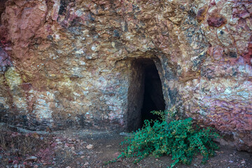 Abandoned gold mine adit in Troodos mountains near Analiontas, Cyprus. The colorful rocks are usual for this area rich of copper ore and sulfides