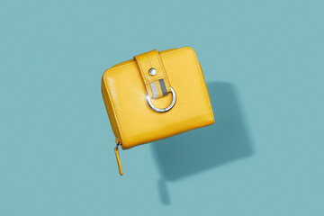 Yellow handbag floating above blue background