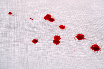 Close up drops of blood on the carpet. cleaning concept. top view