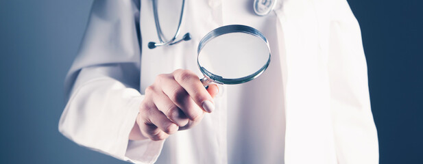 doctor holding a magnifying glass