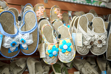 Many home slippers decorated with fabric flowers