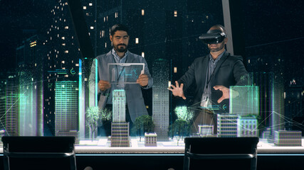 In the Near Future: Professional Designer in Suit wearing AR Headset presenting Architecture Project to Partner standing around Futuristic Table with Holographic Modern Augmented Reality Technology.
