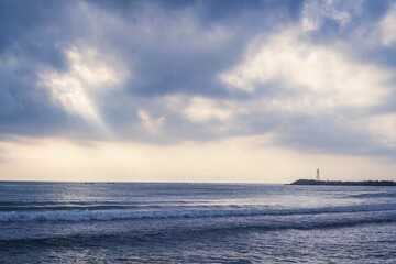 Obraz premium amanecer en playa con. faro de fondo