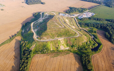 Aerial view of a large green hill in the fields. Ecology pollution garbage landfill