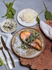 hot dish salmon steak with sorrel sauce on light background top view