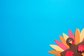 blue background with copy space. paper craft for kids. DIY Turkey made for thanksgiving day. create art for children