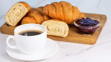 cup of coffee and croissants with jam