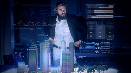 Male Architect works with Holographic Augmented Reality 3D City Model using gestures showing graphs. Technologically Advanced Office with Augmented Virtual Modeling Software on Futuristic Display.