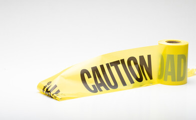 Roll of yellow plastic Caution warning tape used at contruction or emergency locations for safety warning notification on white background