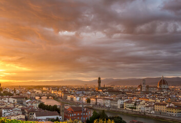 The cityscape of beautiful Florence, Italy, as the cloudy sky erupts with color as the sun sets