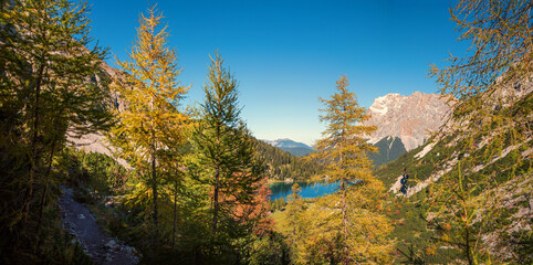 Fototapeta na wymiar hiking trail from Ehrwald to Drachensee, view to lake Seebensee and Zugspitze mountain, austria in autumn