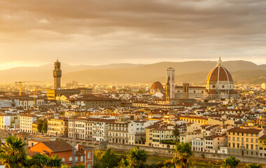Fototapeta na wymiar The cityscape of beautiful Florence, Italy, as the cloudy sky erupts with color as the sun sets