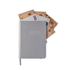 Happy New 2022 Year card. Diary with euro money isolated on white..