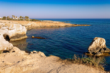 View of the sea caves from a place called Kamara Tou Koraka. Cape Greco National Forest Park on the island of Cyprus. Coast at sunset.