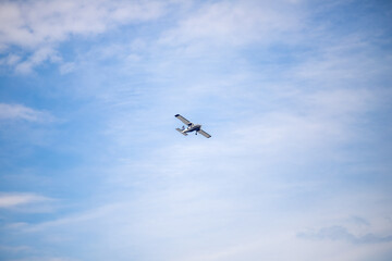 propeller plane flying in the blue sky.