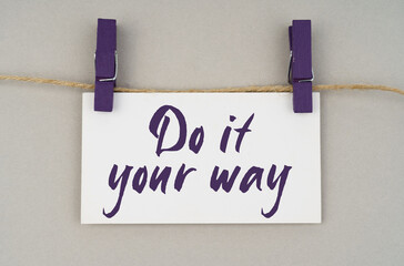 On a gray background, a business card with the inscription -