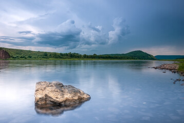 Landscapes of Siberia. Evening landscape on the Kiya river. Mountains, forest, river and water at long exposure. Kemerovo region. Russia
