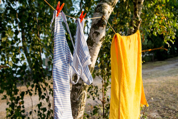 women's swimsuit and yellow towel dry in the sun