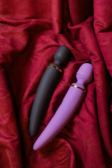 Woman in bedroom holding vibrator in hand.