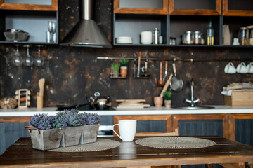 Obraz na płótnie Canvas A pot with a plant on the kitchen table. Kitchen, kitchen interior.