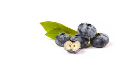 Fresh blueberries (Cyanococcus within the genus Vaccinium) with sliced berry and green leaves isolated on white background. 