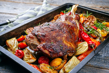 Traditional barbecue lamb shoulder with vegetables and chili served as close-up on a rustic metal...