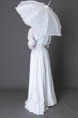 An Edwardian woman wearing a white lace trimmed blouse and skirt © Kathy