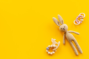 Knitted baby toy rabbit for newborn with wooden toys, top view