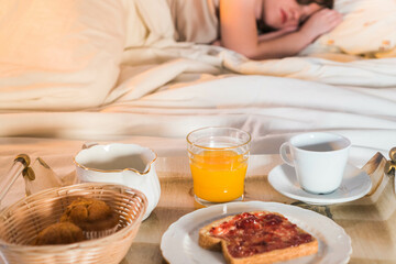 Girl sleeping with a breakfast in her bed