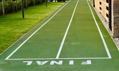 Fototapeta premium Finish line on the green surface