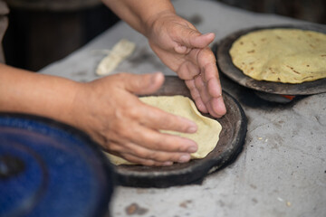 Comal making corn tortillas on traditional fire