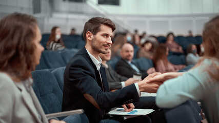 business seminar participants greet each other with a handshake