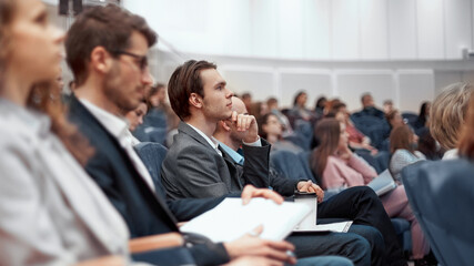 young business people listening to a lecture in the conference hall. - obrazy, fototapety, plakaty