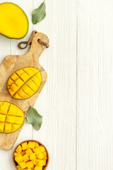 Mango fruit and mango cubes in bowl. Fruits background