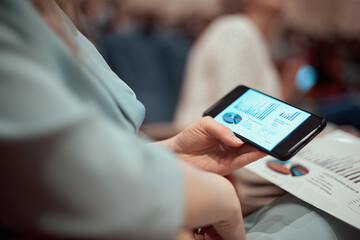 close-up. businesswoman with a smartphone sitting in the conference hall.