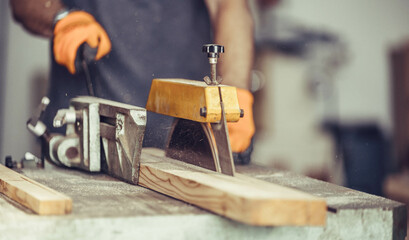 Carpenter cuts wood on an electric saw.