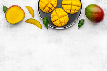 Plate of mango fruits and mango cubes. Tropical breakfast. Top view