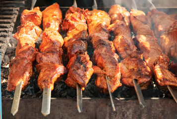 delicious barbecue grilled on an open fire on an open kitchen. Food festival in the city on the street. Pork fried on a skewer on a food court for a summer picnic. Grilled shish kebab.