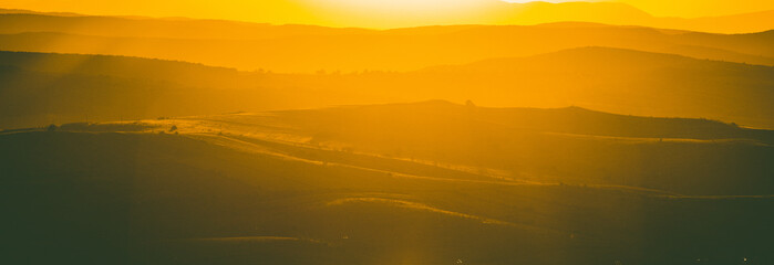 autumn landscape with hills in sunset light