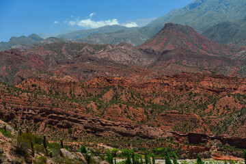 The red rock landscape of the Sierra de Famatina mountain range from the scenic Cuesta de Miranda stretch of the famous Ruta 40 National Route, La Rioja, Argentina