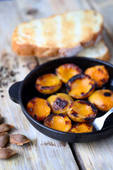 Halves of apricot in a frying pan. Grilled apricots. Fried apricots.