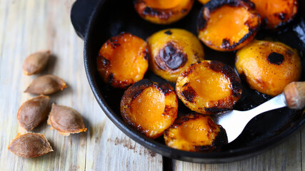 Halves of apricot in a frying pan. Grilled apricots. Fried apricots.