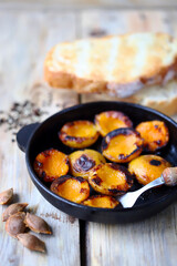 Halves of apricot in a frying pan. Grilled apricots. Fried apricots.