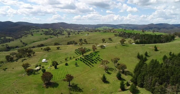 Cultivated gardens and pastures in rural country of Australia as aerial 4k.
