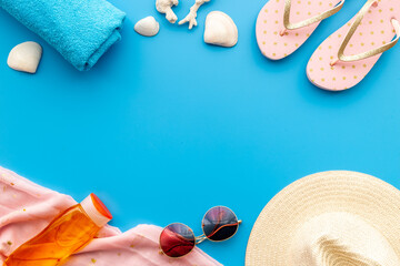 Frame of beach accessories with sraw hat, sunglasses and flip flops