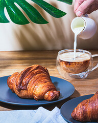 Croissant and coffee whit milk breakfast 