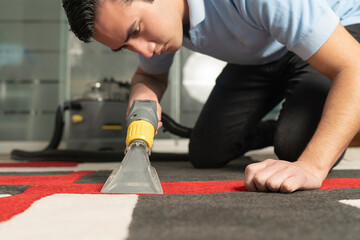 Close up of laundry worker cleaning carpet with special equipment