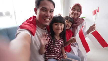 indonesian asian family making selfie and video call using their phone at home