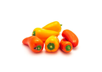 Pile of colorful orange and red mini sweet peppers snack isolate on white
