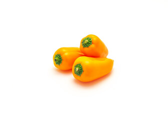 Three organic orange mini sweet peppers snack isolate on white